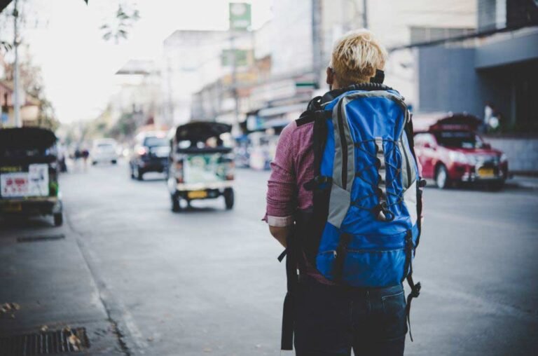 Woman backpacking in busy street